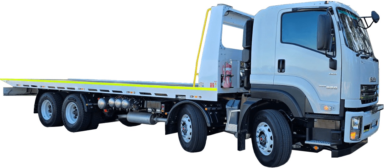 Side view of a large white flatbed tow truck prepared for heavy-duty hauling.